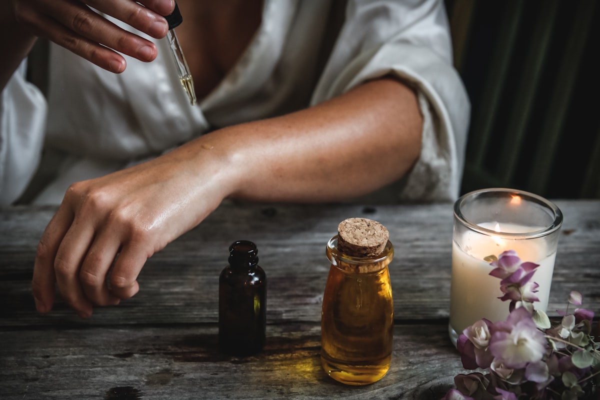 Massage oils and folded towels beside a treatment table