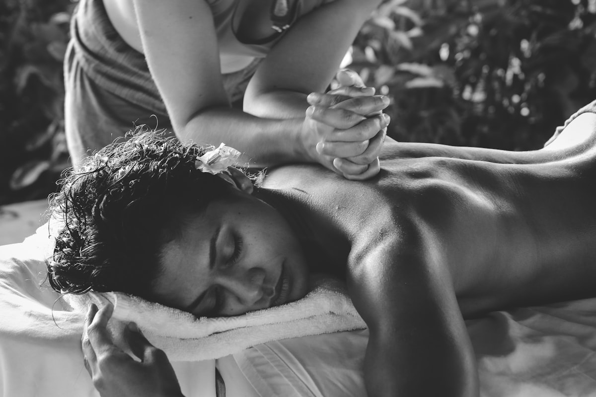 Rolled towels, oils, and soft light in the treatment room